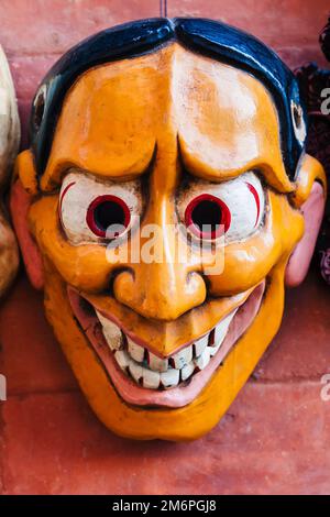 Colorful wooden mask or handicraft kept for sale at the shop in Swayambhunath, Kathmandu Nepal. Stock Photo