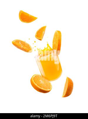 Glass of orange juice with splash and orange slices falling, isolated on white. Stock Photo