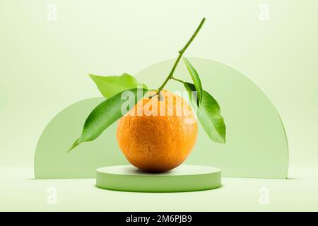 Orange juice with leaves on green background with pedestal. Stock Photo