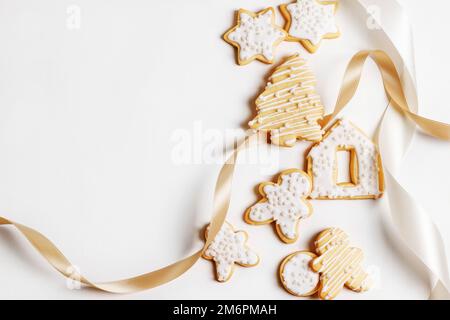 Christmas cookies with icing on a white background with ribbon Stock Photo