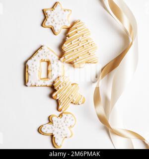 Christmas cookies with icing on a white background with ribbon Stock Photo