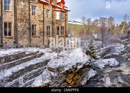 Fife Arms Hotel Braemar Scotland winter and the banks of Clunie Water covered by snow Stock Photo