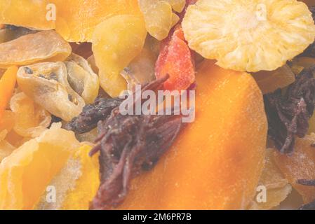 Mix of dried exotic fruit, mangos,slices of pineapples, passion fruit, papaya. Vegetarian dessert. Stock Photo