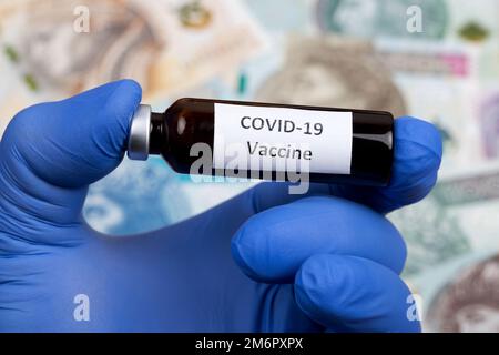 Vaccine against covid-19 on the background of Polish money Stock Photo