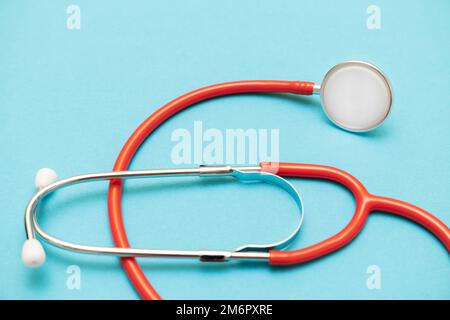 medical stethoscope on a blue background shot with blur. close-up shot of a stethoscope. medical instrument. medical background. High quality photo Stock Photo
