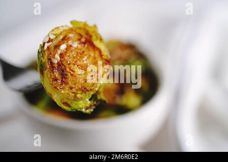 Roasted Teriyaki Brussels sprouts served in a bowl, selective focus Stock Photo