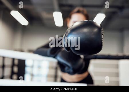 Strong latin boxing woman on the ring at fitness gym. Athletic girl training Muay Thai boxing for bodybuilding and healthy lifes Stock Photo