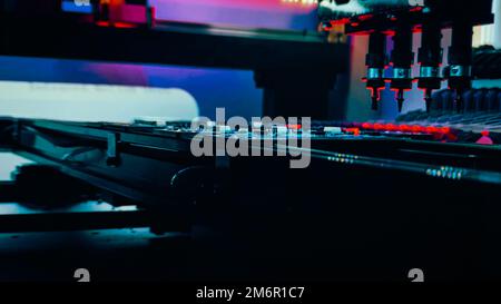 Automated production of computer system boards by Pick and Place robot. Robot Manipulators for assembling computer chips and system computer boards place electronic components on board for fixing. Stock Photo