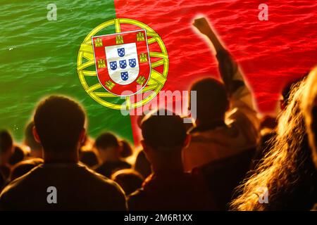 Defocus Portugal football team. supporters on stadium. Portugal flag and football fans celebrating victory. Protest in Portugal. Rise hand. Out of Stock Photo