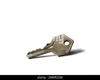 Isolated metal padlock key on white background. Stock Photo