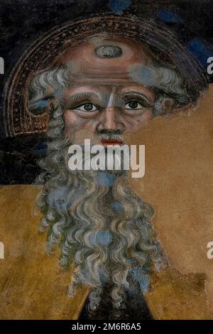 Saint Anthony the Abbot: partial circa 1380s fresco of venerable patriarch with bald head, staring eyes and curly grey beard by Sienese School artists Cristoforo di Bindoccio and Meo di Piero in the Chiesa di San Francesco, the Franciscan church at Pienza, Val d’Orcia, Tuscany, Italy. Stock Photo