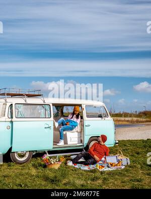 Old vintage green van parked in a street with Victorian houses in the ...