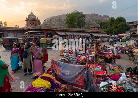 Jodhpur, Rajasthan, India - 20.10.2019 : Foreigners buying Rajasthani womens clothes being sold at Famous Sardar Market and Ghanta ghar Clock tower in Stock Photo