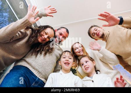 Happy large caucasian family with many children making selfie photo at home, waving hands at camera Stock Photo