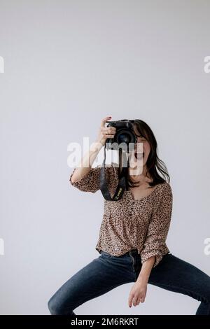 Woman in action with camera Stock Photo