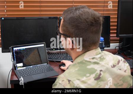 U.S. Air Force Senior Airman Daenon Davy, 47th Operations Support Squadron air traffic controller, runs an air traffic control simulator for practice at Laughlin Air Force Base, Texas, May 4, 2022.  The simulator allows Airmen to train for day-to-day air traffic scenarios without the stress of real-world situations. Stock Photo