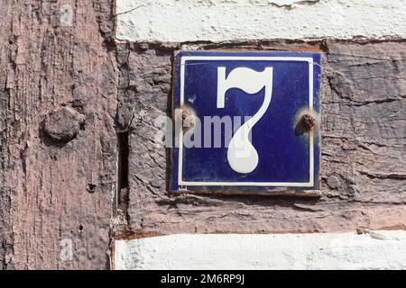 House number sign, number seven on an old half-timbered house, Nienburg an der Weser, Lower Saxony, Germany Stock Photo