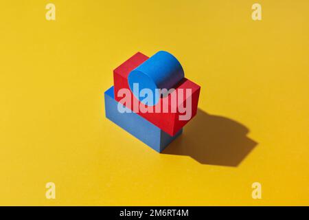 Abstract colored geometric shape red and blue on yellow background. Minimal geometric shapes Stock Photo