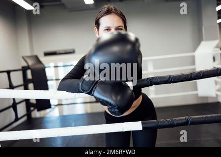 Strong latin boxing woman on the ring at fitness gym. Athletic girl training Muay Thai boxing for bodybuilding and healthy lifes Stock Photo