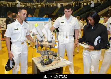 ANNAPOLIS, Md. (May 4, 2022) U.S. Naval Academy midshipmen present their capstone project in Alumni Hall. The capstone (senior design) project is the culminating academic experience for the 1/C midshipmen (seniors) who undertake ambitious, year-long projects that involve creative design, fabrication, and actual system operation/demonstration. As the undergraduate college of our country's naval service, the Naval Academy prepares young men and women to become professional officers of competence, character, and compassion in the U.S. Navy and Marine Corps. Stock Photo