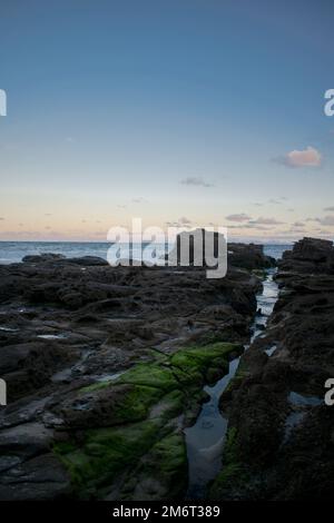 Sunset on a stony coast Australia Stock Photo