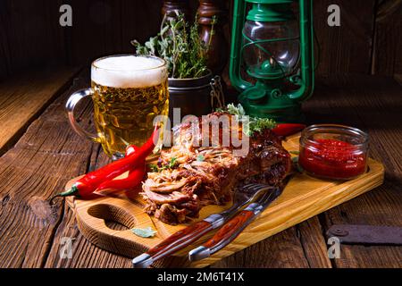 Pulled pork out of the oven with beer sauce Stock Photo