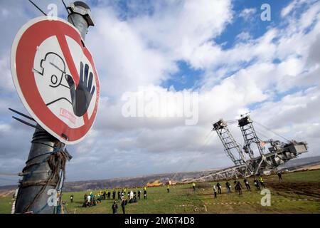 Warning sign, in the background the Garzweiler opencast mine, a bucket wheel excavator, general, feature, marginal motif, symbolic photo The village of Luetzerath on the west side of the Garzweiler opencast lignite mine will be cleared and dredged in January 2023, Luetzerath, 05.01.2023, Stock Photo