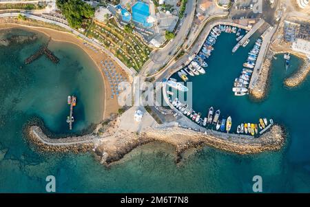 Drone aerial scenery fishing port at pernera Protaras Cyprus. Fishing boats moored in the harbour Stock Photo