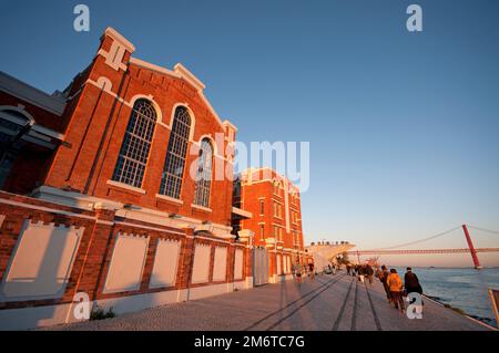 Electricity Museum (former power plant) along Tagus riverside, in the background the MAAT Museum and 25 April bridge, Belem district, Lisbon, Portugal Stock Photo