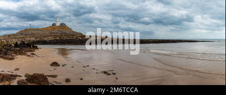 A panorama view of the Mumbles headland with the historic lighthouse in Swansea Bay Stock Photo
