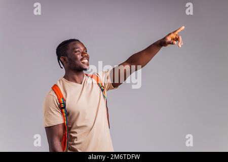 hispanic student man with rainbow badge on t-shirt in studio isolate Stock Photo