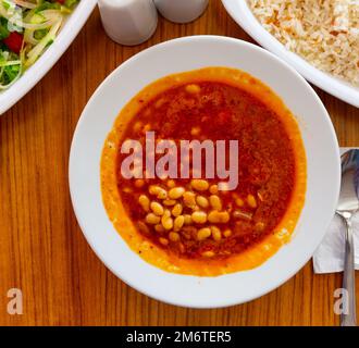 Turkish stew of white bean Kuru fasulye with salad and rice Stock Photo