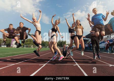 Female coach and group of children conducts a training session Stock Photo