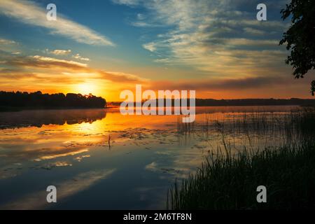Pastoral landscape with dramatic sky on the lake in Belarus Stock Photo
