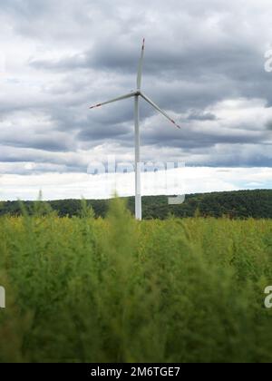 Clean electricity producing wind turbines built on a windy mountain ridge Stock Photo