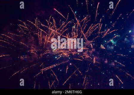 Beautiful multi-colored fireworks against the background of the night sky. High quality photo Stock Photo