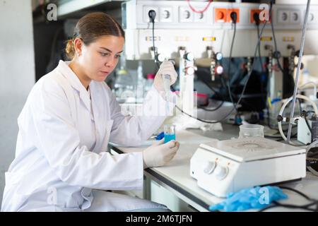 Shot of an young woman using equipment to work in a laboratory Stock Photo