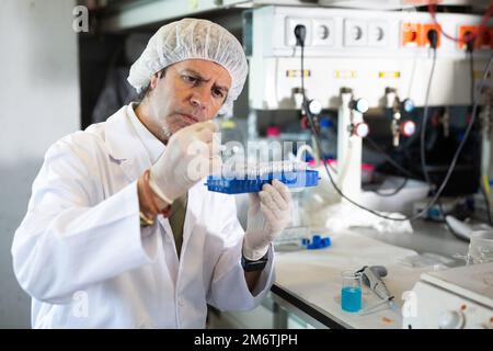 Portrait of an adult male using equipment to work in a laboratory Stock Photo