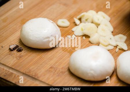 chopped garlic, mushrooms on a chopping board ready for cooking Stock Photo