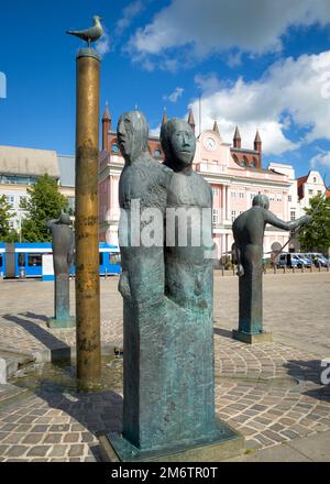 Town hall rostock germany with well in foreground Stock Photo