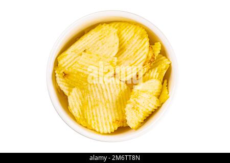 Top view closeup pile of dried crispy salted potato chips in white ceramic bowl isolated on white background. Stock Photo