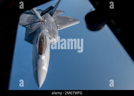 A KC-135 Stratotanker assigned to the 117th Air Refueling Wing, Alabama Air National Guard, provides fuel to a F-22 Raptor over the Georgia coast during the Sentry Savannah exercise on May 5, 2022. During the exercise, fighter jets receive assistance from refueling tankers assigned to the 117th AFW, the 157th Air Refueling Wing from the New Hampshire Air National Guard, and the 190th Air Refueling Wing from the Kansas Air National Guard so they may continue their aerial combat training. Stock Photo