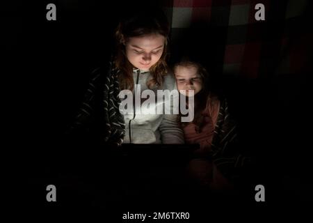 Blackout. Energy crisis. Power outage concept. Girl holds in her hands two  burning candles with a yellow-blue ribbon (the national symbol of Ukraine  Stock Photo - Alamy
