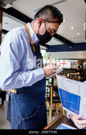 Mexico City,Juarez Cuauhtemoc Avenida Paseo de la Reforma,Taqueria El Califa,writing taking order menu,man men male adult adults resident residents,in Stock Photo