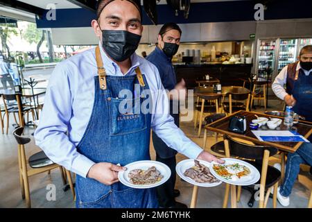 Mexico City,Juarez Cuauhtemoc Avenida Paseo de la Reforma,Taqueria El Califa,serving lunch,man men male adult adults resident residents,inside interio Stock Photo