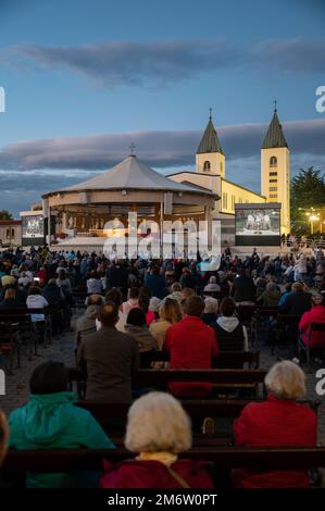 Pilgrims adoring Jesus Christ present in the Blessed Sacrament after the evening Holy Mass in Medjugorje, Bosnia and Herzegovina. Stock Photo