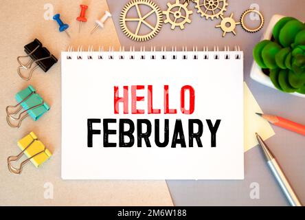 Hello February - handwriting on a napkin with a cup of coffee. Stock Photo