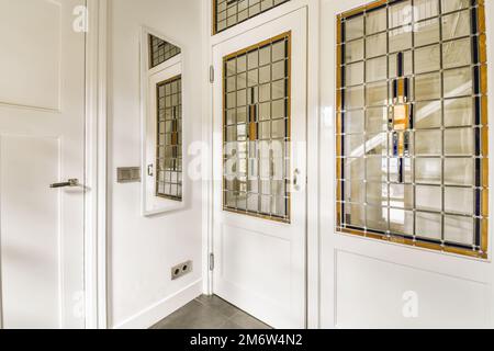 the inside of a house with white doors and glass window panes on either side by side to each other windows Stock Photo