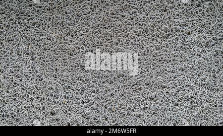 Foot mat rug texture with rubber material, patterned doormat rug background. Stock Photo