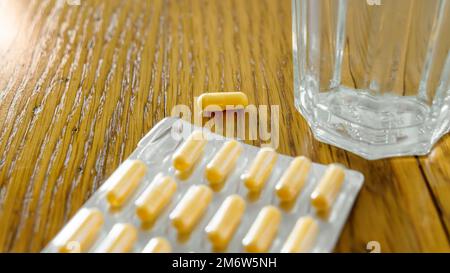 Yellow pills in a blister pack Stock Photo